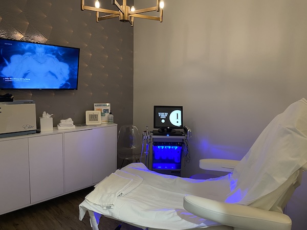 Clinical treatment room featuring a reclining chair and soft blue lighting