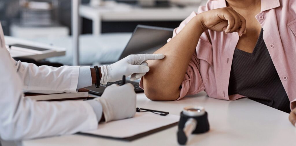 Doctor examining patient skin for eczema treatment in Franklin TN